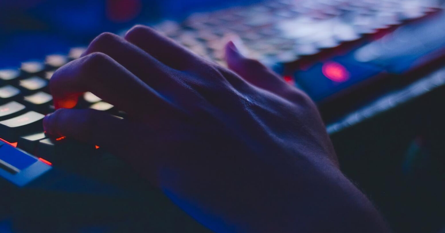 A developer reviewing code on a laptop with a browser window showing a running ephemeral environment